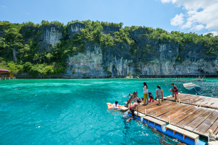 Local kids jumping into the water at the Karamba resto