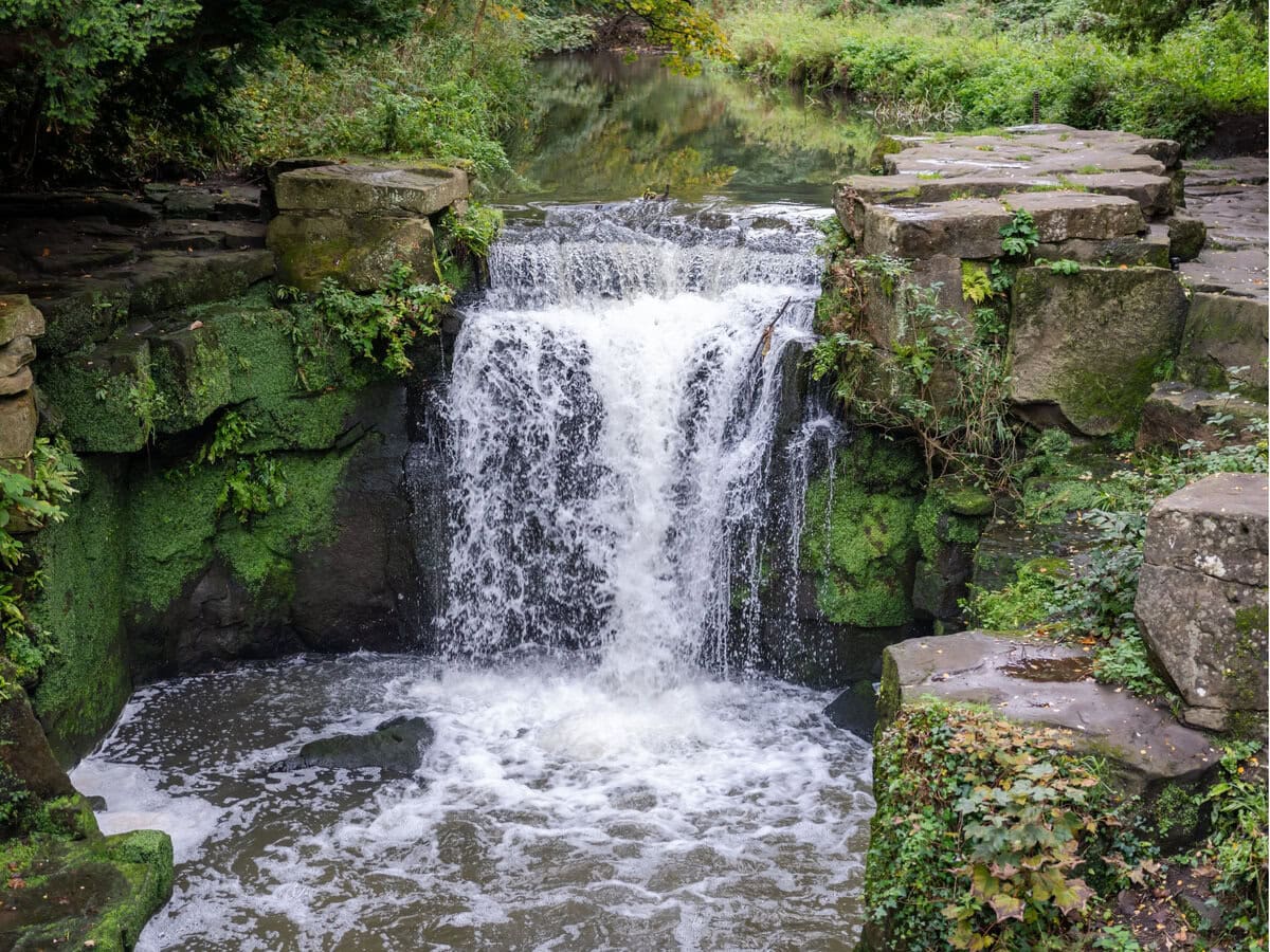 A Waterfall in a Park in Newcastle, Uk Surrounded by Rocks