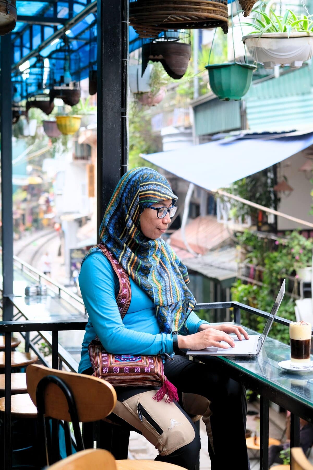 Woman Working with Her Laptop at a Cafe in Hanoi
