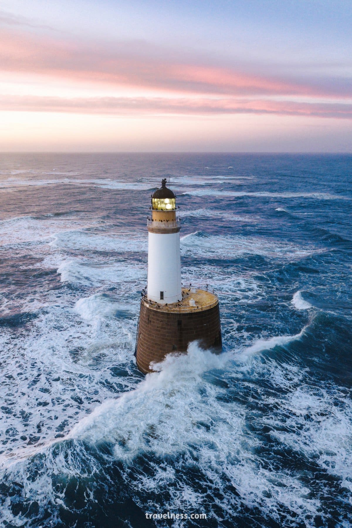Waves Hitting a Lighthouse in Scotland