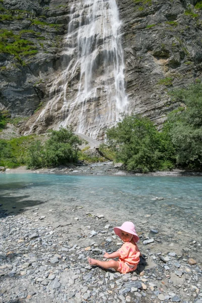 Baby playing in the creek at Schreyenbachfall waterfall