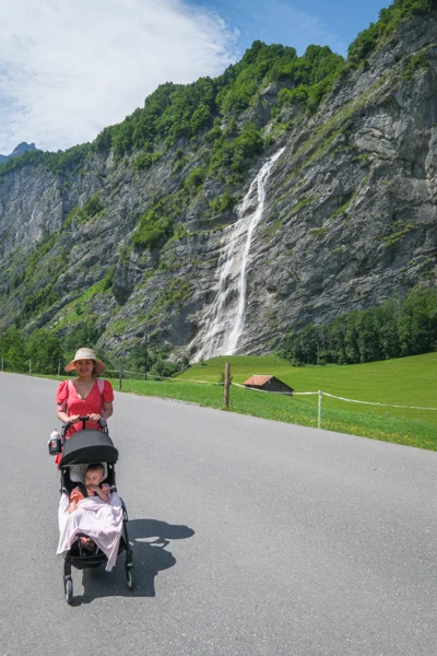 Woman pushing a baby stroller at Schreyenbachfall waterfall